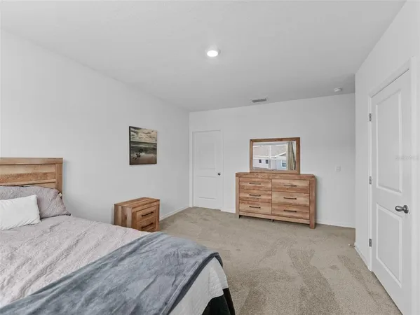 a bedroom with a bed and cabinets
