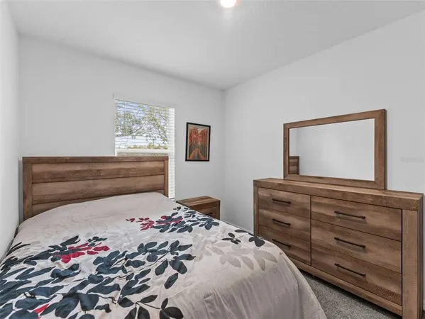 a bedroom with a bed and a dresser
