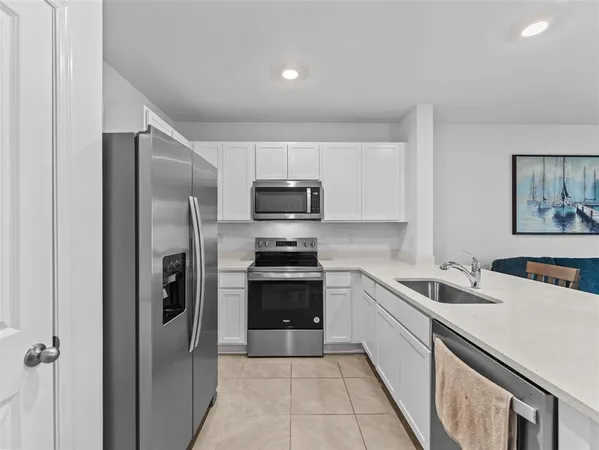 a kitchen with a sink stainless steel appliances and cabinets