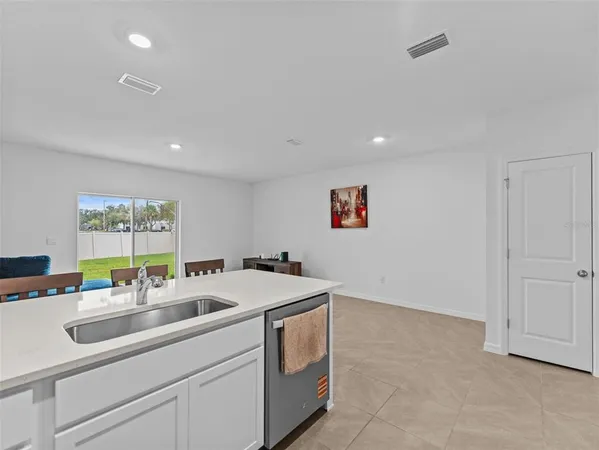a kitchen that has a sink and a stove in it