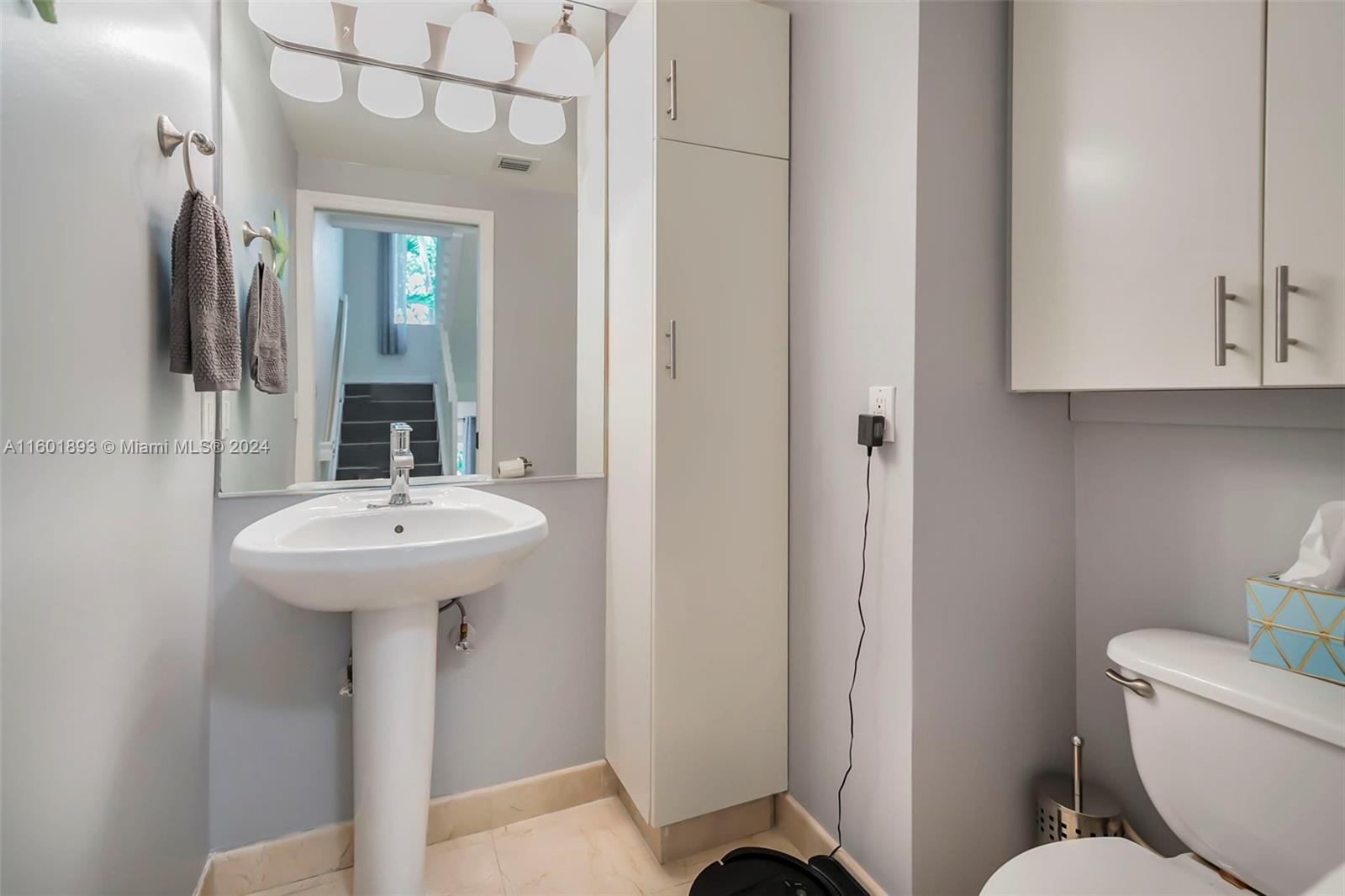 3204 Bird Avenue, Unit 109 Miami, FL 33133 - Photo 13 of 67 a bathroom with a sink and mirror