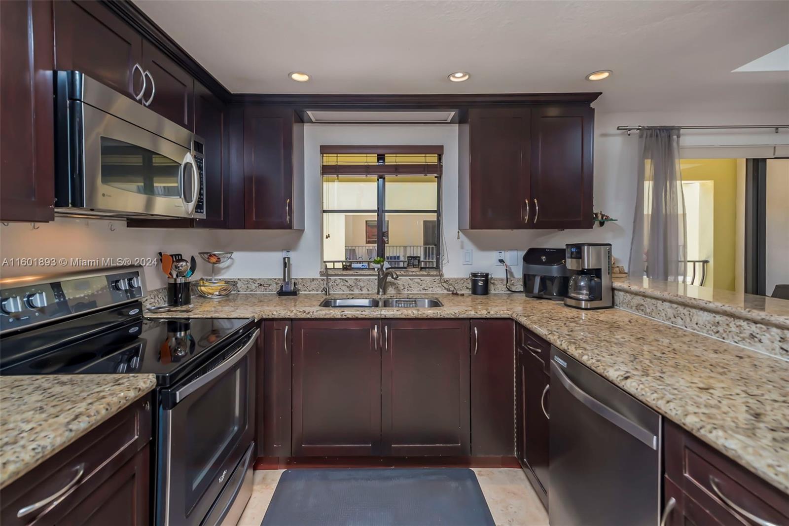 3204 Bird Avenue, Unit 109 Miami, FL 33133 - Photo 20 of 67 a kitchen with a sink stove top oven and microwave