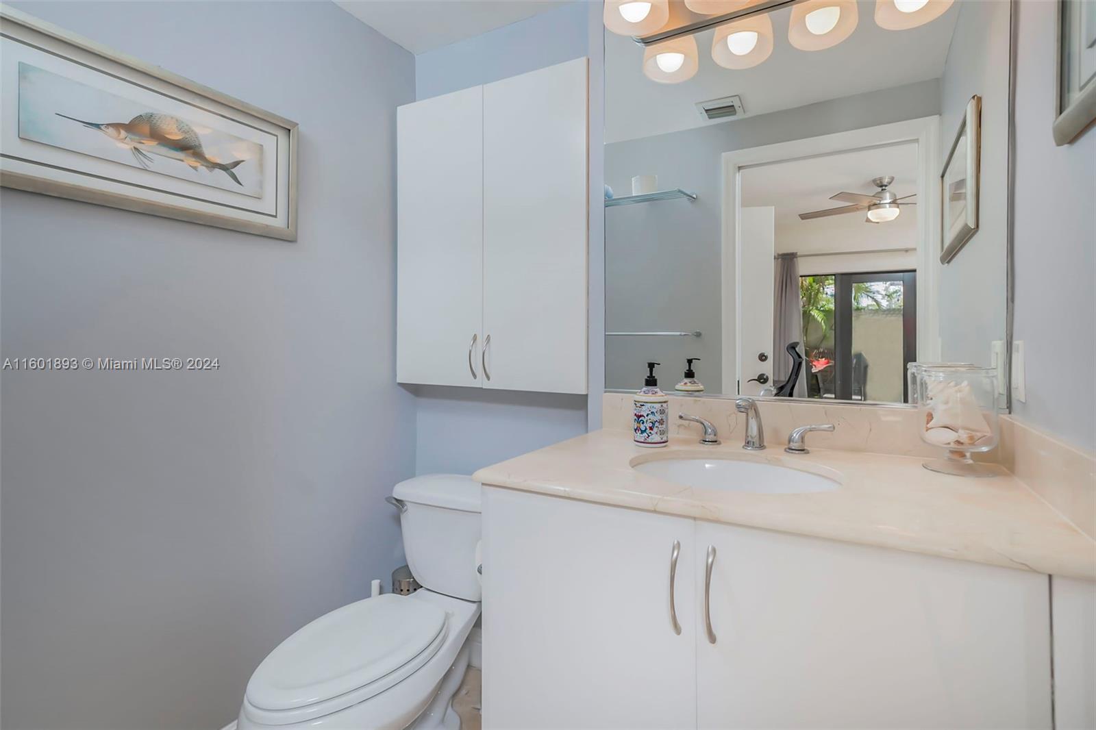 3204 Bird Avenue, Unit 109 Miami, FL 33133 - Photo 21 of 67 a bathroom with a sink vanity mirror and toilet
