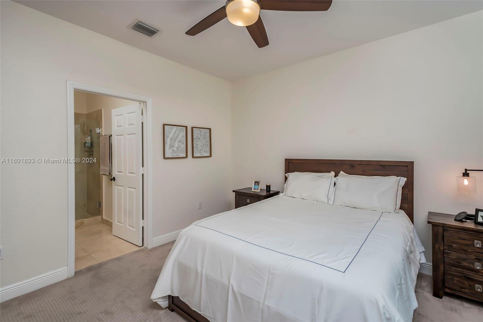 3204 Bird Avenue, Unit 109 Miami, FL 33133 - Photo 24 of 67 a bedroom with a bed and a chandelier