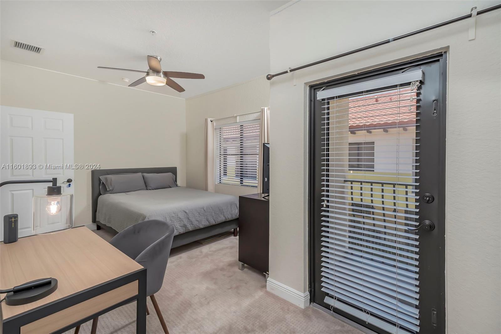 3204 Bird Avenue, Unit 109 Miami, FL 33133 - Photo 25 of 67 a bedroom with a bed and a chandelier