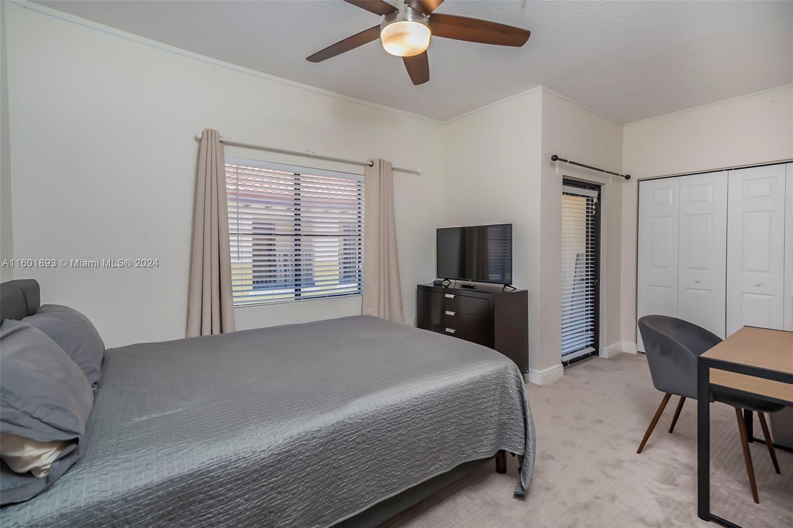 3204 Bird Avenue, Unit 109 Miami, FL 33133 - Photo 26 of 67 a bedroom with a bed flat screen tv and a window