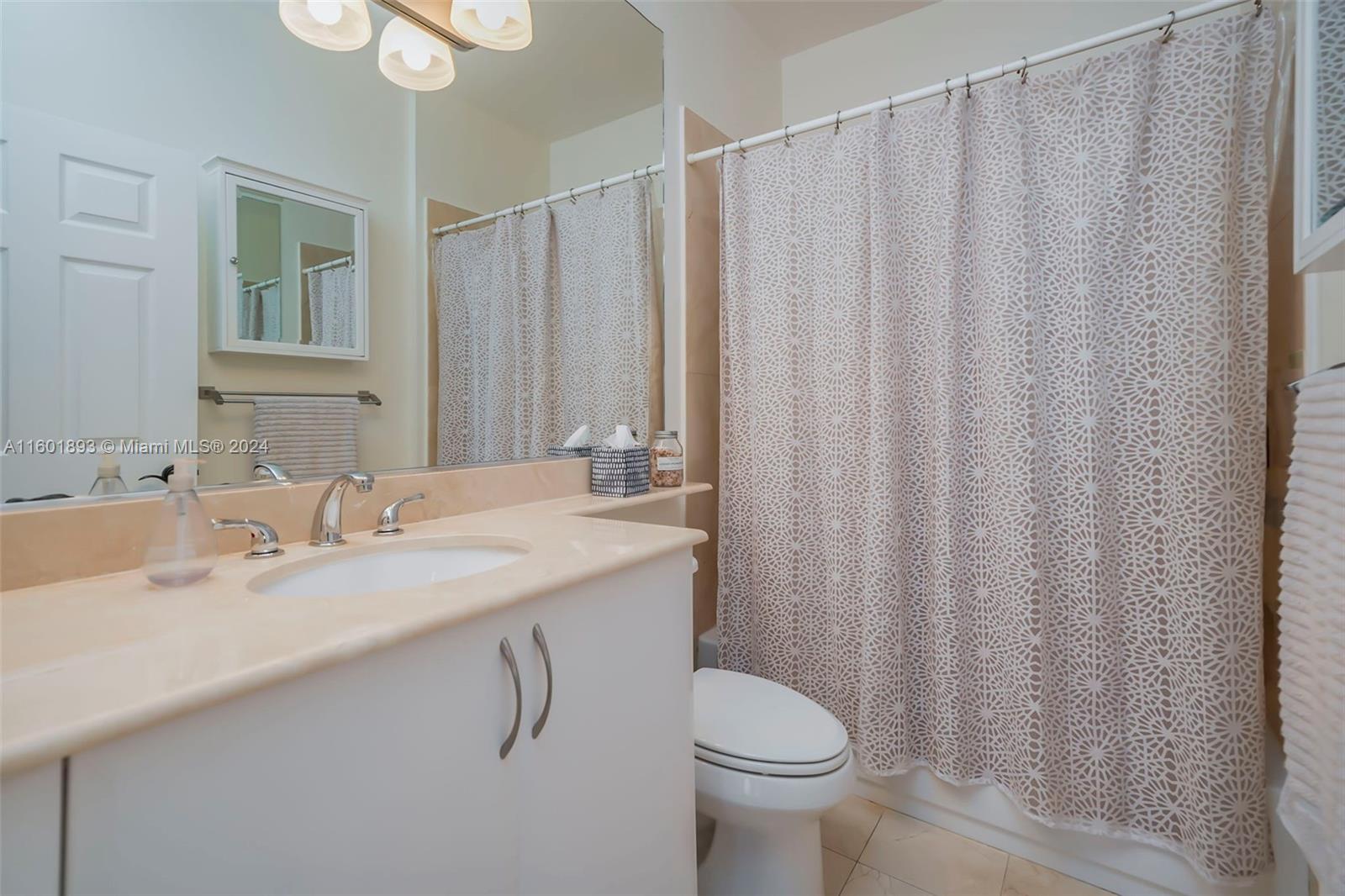3204 Bird Avenue, Unit 109 Miami, FL 33133 - Photo 28 of 67 a bathroom with a granite countertop sink and a mirror