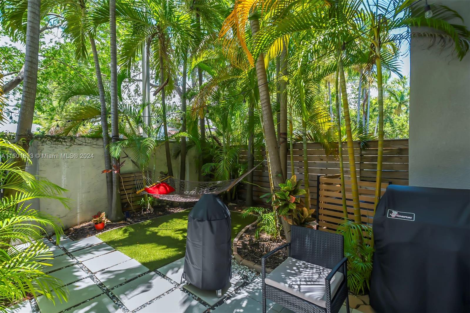 3204 Bird Avenue, Unit 109 Miami, FL 33133 - Photo 35 of 67 a backyard of a house with lots of green space and outdoor seating