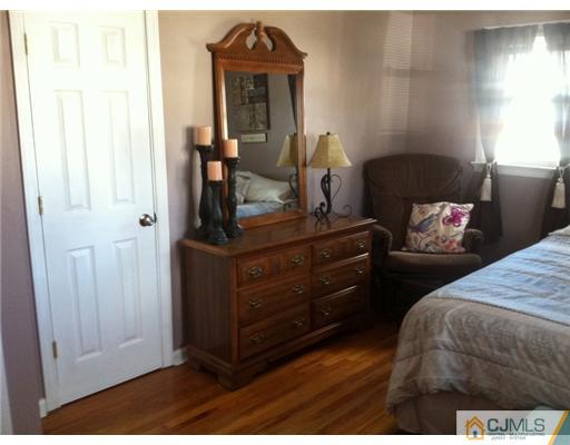 19 Weiss Terrace Raritan, NJ 08869 - Photo 8 of 12 a bedroom with a bed and wooden floor