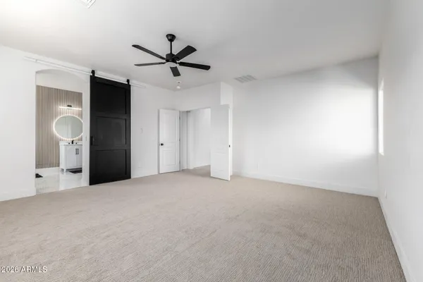 a view of a big room with closet and windows