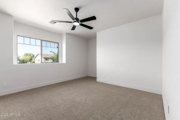 a view of a room with a ceiling fan