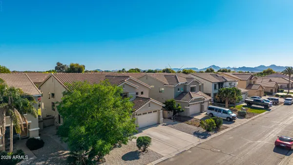 a kitchen with stainless steel appliances granite countertop a sink dishwasher a stove a refrigerator a microwave oven with white cabinets and wooden floor