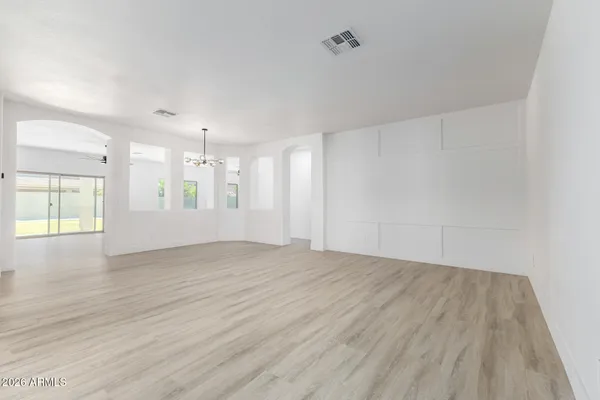 a view of a livingroom with wooden floor and a ceiling fan