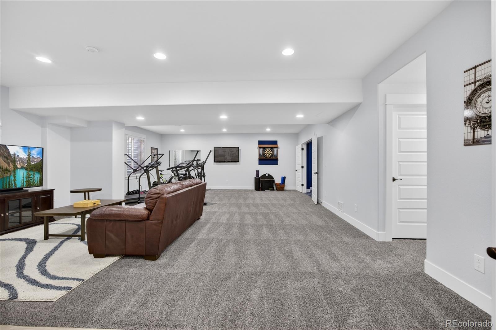 20554 East Shady Ridge Road Parker, CO 80134 - Photo 33 of 49 a living room with furniture and a flat screen tv