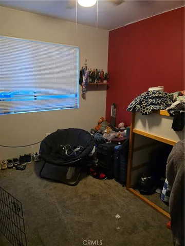 a bedroom with a bed and a chair