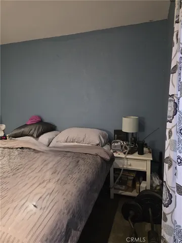 a bedroom with a bed and dresser