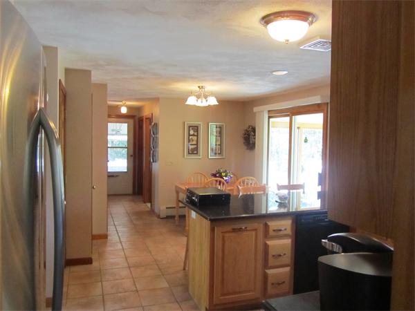 76 Emerson Road Walpole, MA 02032 - Photo 3 of 15 a kitchen with sink and refrigerator