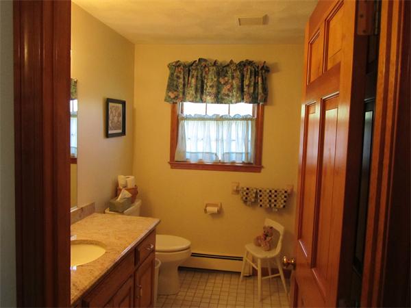 76 Emerson Road Walpole, MA 02032 - Photo 8 of 15 a bathroom with a granite countertop sink and a mirror