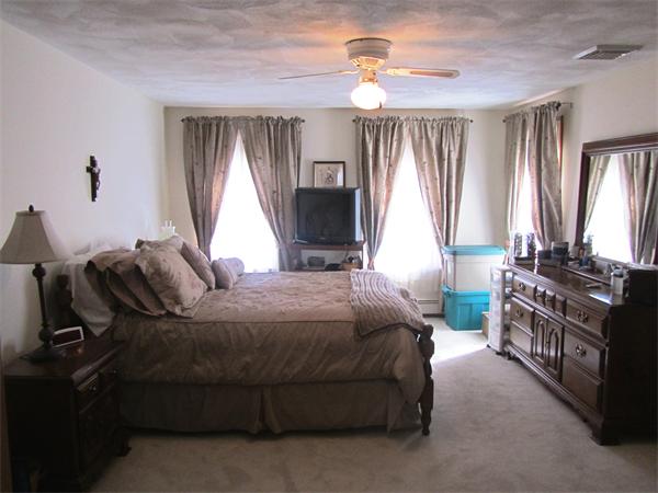 76 Emerson Road Walpole, MA 02032 - Photo 9 of 15 a bedroom with a bed and a chandelier
