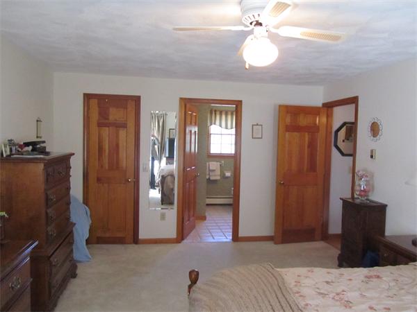 76 Emerson Road Walpole, MA 02032 - Photo 10 of 15 a bedroom with a bed and a chandelier