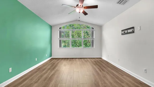 wooden floor in an empty room with a window