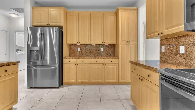 a kitchen with granite countertop white cabinets white stainless steel appliances with a sink and dishwasher