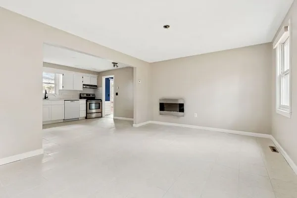 a view of a kitchen with a sink and a refrigerator