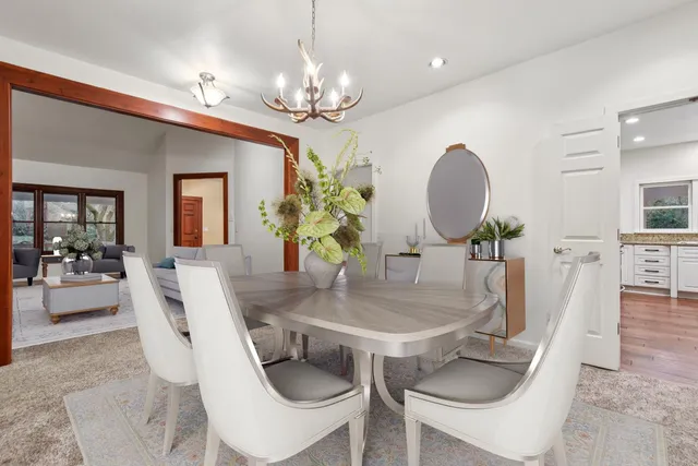 a view of a dining room with furniture and chandelier