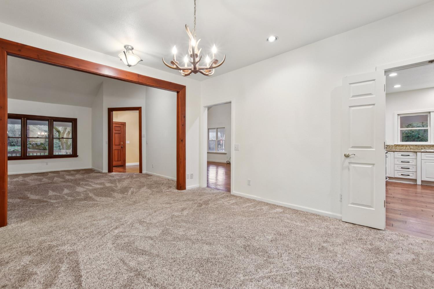 7650 Buzzards Gulch Road Somerset, CA 95684 - Photo 14 of 39 a view of an empty room with chandelier and kitchen