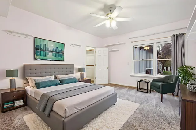 a bedroom with a bed a table and chair