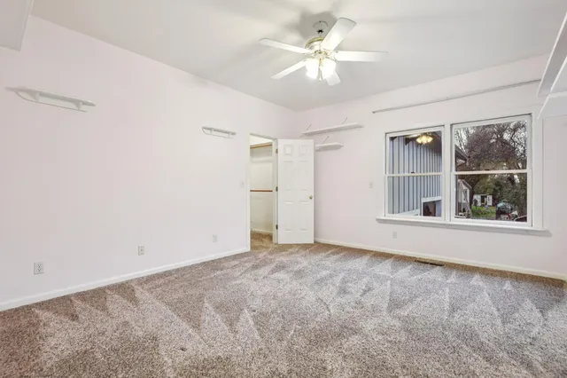 an empty room with windows and closet