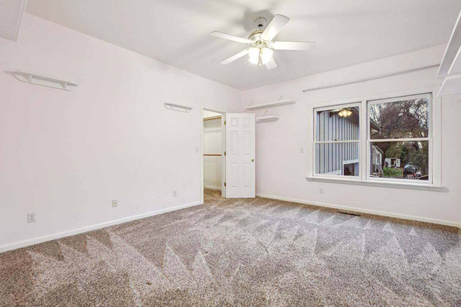 7650 Buzzards Gulch Road Somerset, CA 95684 - Photo 20 of 39 an empty room with windows and closet