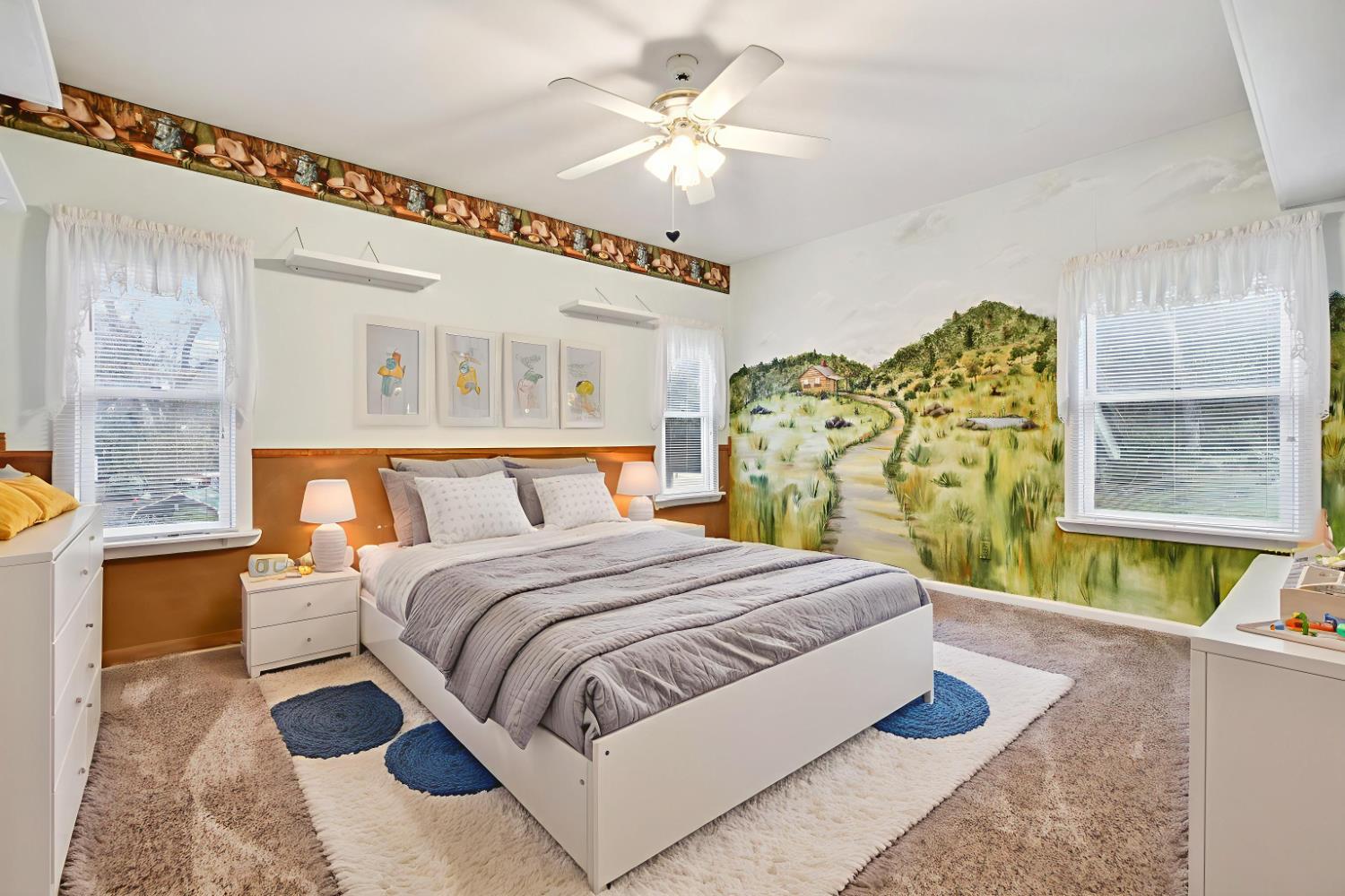 7650 Buzzards Gulch Road Somerset, CA 95684 - Photo 21 of 39 a spacious bedroom with a bed and a chandelier