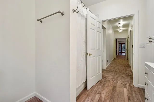 a view of a hallway with wooden floor