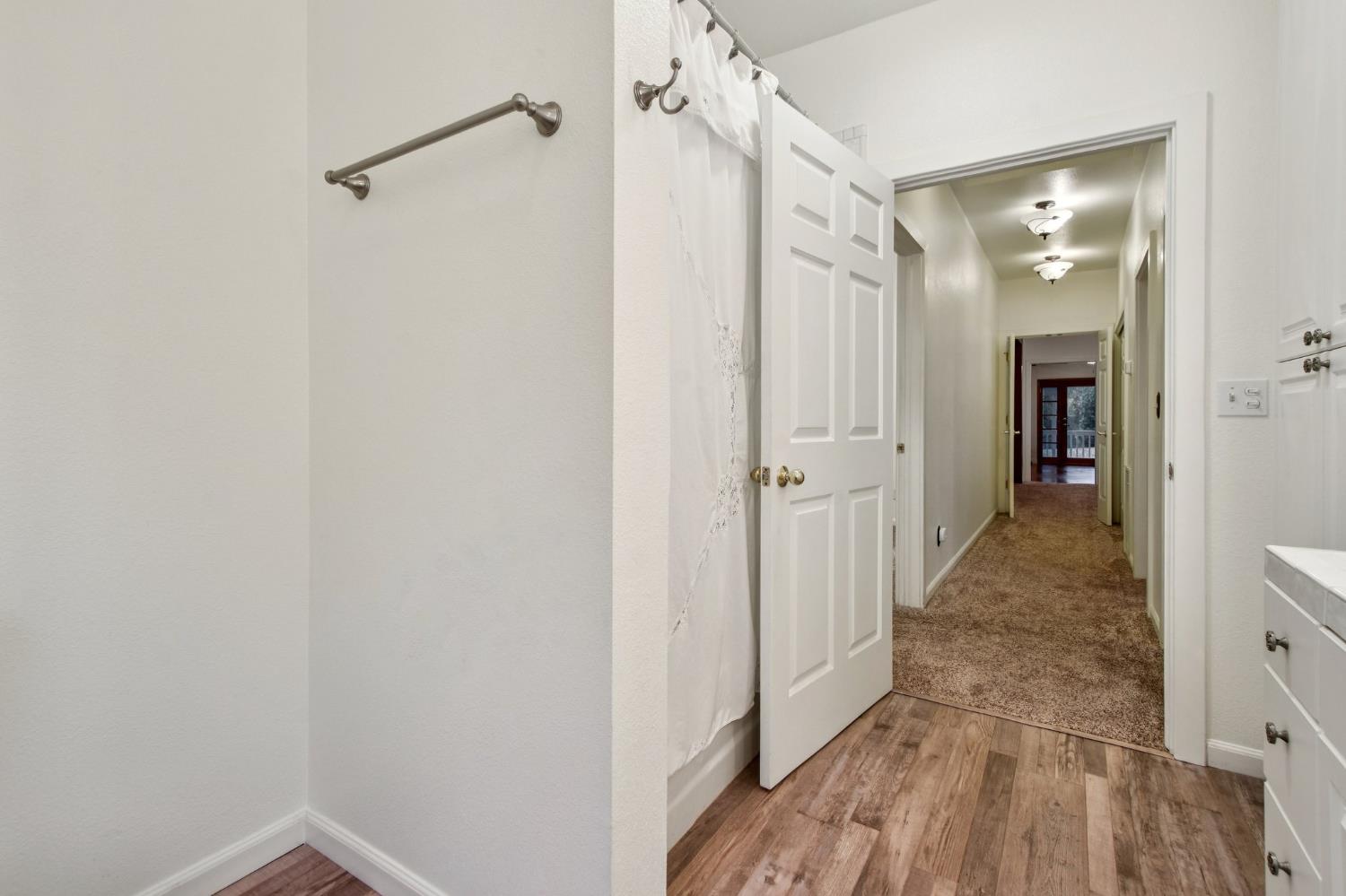 7650 Buzzards Gulch Road Somerset, CA 95684 - Photo 23 of 39 a view of a hallway with wooden floor