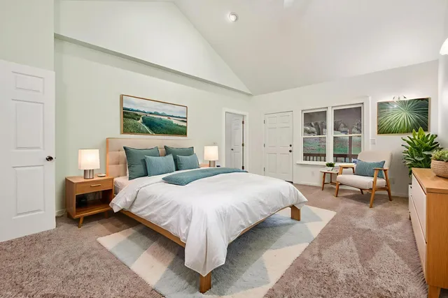 a bedroom with a large bed and a window