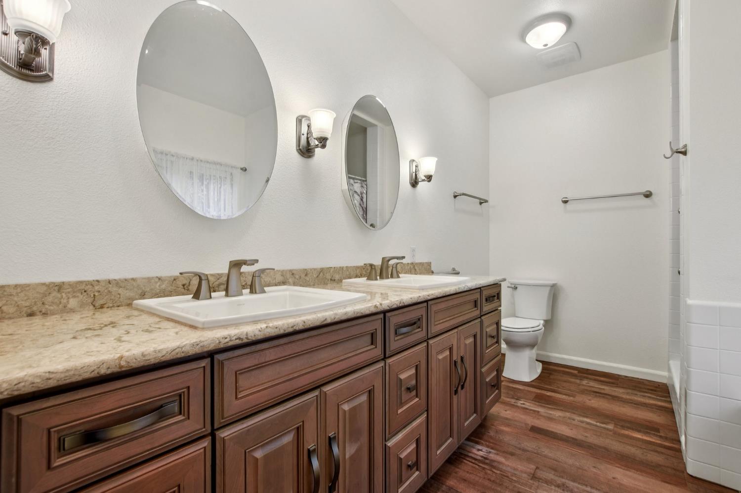 7650 Buzzards Gulch Road Somerset, CA 95684 - Photo 28 of 39 a spacious bathroom with a double vanity sink and a mirror