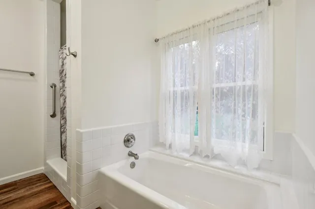 a bathroom with a bathtub and a shower