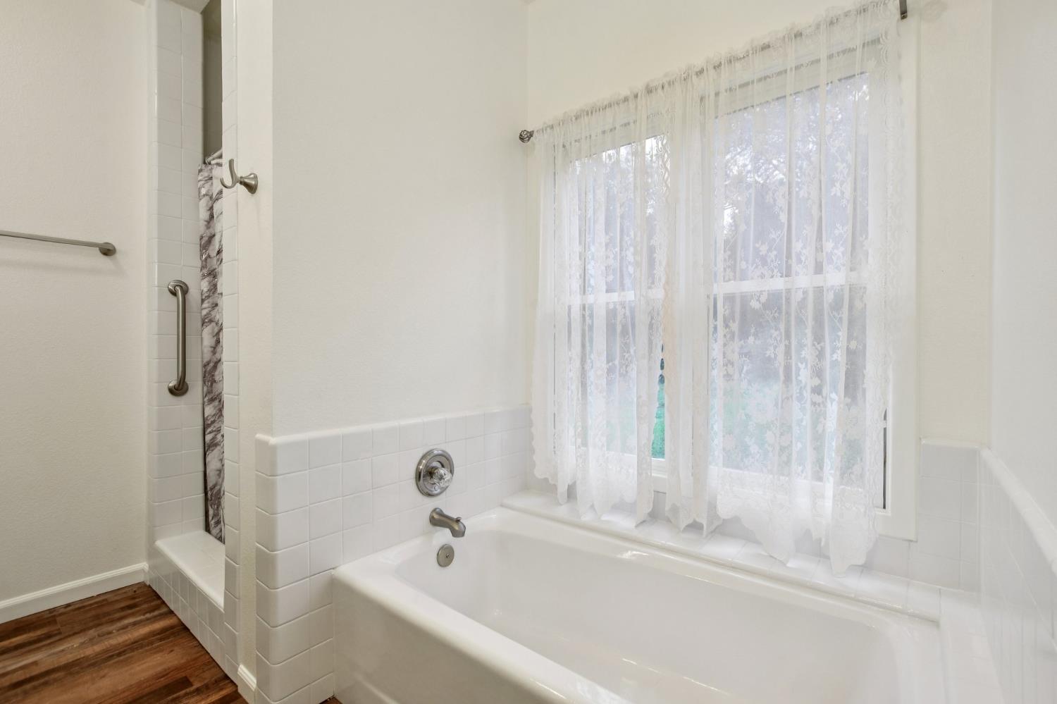 7650 Buzzards Gulch Road Somerset, CA 95684 - Photo 29 of 39 a bathroom with a bathtub and a shower
