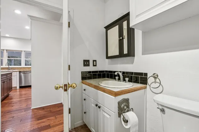a bathroom with a granite countertop sink and a mirror