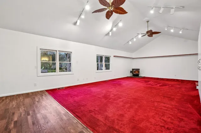 a view of empty room with a window and ceiling fan