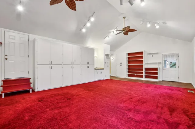 a view of empty room with cabinet and ceiling fan