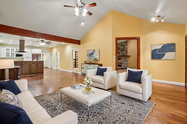 a living room with furniture and wooden floor