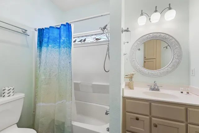 a bathroom with a sink a mirror and a shower