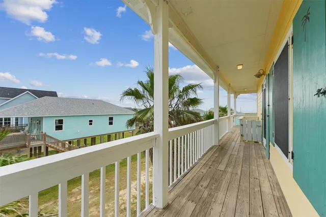 a view of a balcony with wooden floor