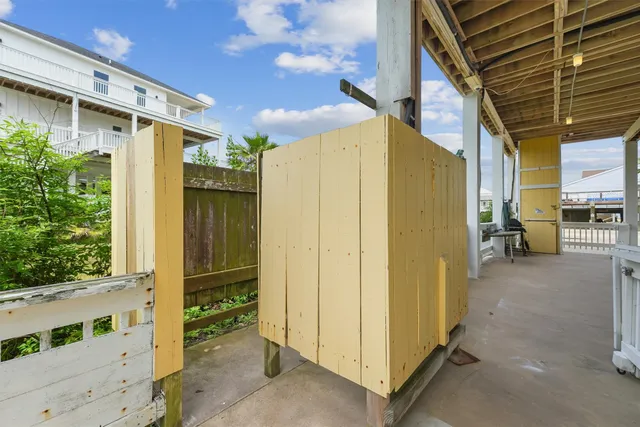 a view of a porch with furniture and a yard
