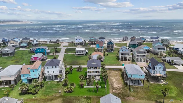 an aerial view of multiple houses with a yard