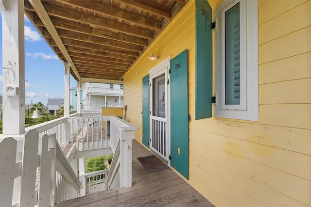 a view of balcony with wooden floor and outdoor seating