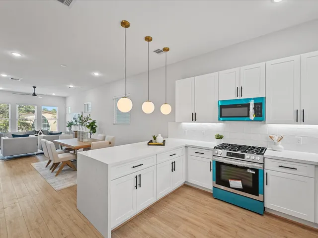 a kitchen with a stove a sink and a refrigerator