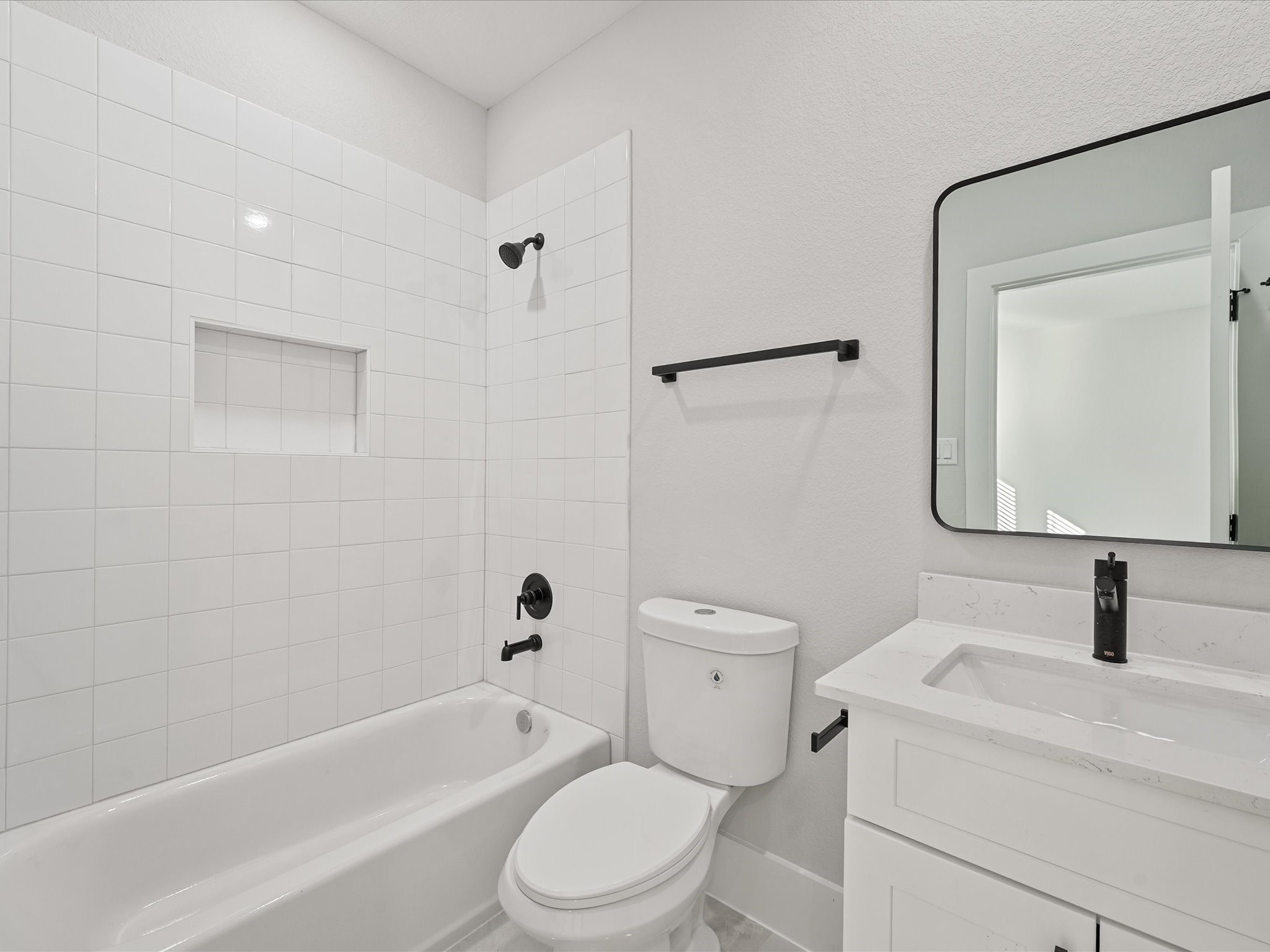 4812 Cochran Street Houston, TX 77009 - Photo 24 of 30 a bathroom with a toilet sink a mirror a vanity and bathtub